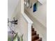 View of a staircase with wood steps and white railing and decorated with art at 4703 Somerset Hill Ln, Riverview, FL 33578