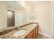 Bathroom featuring double vanity, granite countertop, and modern fixtures at 4760 Wheel House Dr, New Port Richey, FL 34652