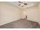Bedroom features plush carpeting, ceiling fan and ensuite bathroom access at 4760 Wheel House Dr, New Port Richey, FL 34652