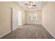 Bedroom features plush carpeting, ceiling fan and bright window with shutters at 4760 Wheel House Dr, New Port Richey, FL 34652
