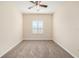 Bedroom features plush carpeting, ceiling fan and bright arched window with shutters at 4760 Wheel House Dr, New Port Richey, FL 34652