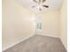 Bright bedroom featuring neutral carpet, paint, ceiling fan, and a window with plantation shutters at 4760 Wheel House Dr, New Port Richey, FL 34652