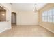 Spacious dining area with tile flooring, a chandelier, and natural light creating a welcoming atmosphere at 4760 Wheel House Dr, New Port Richey, FL 34652