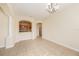 Open-concept dining area with tile flooring, a chandelier, and views into the kitchen and living spaces at 4760 Wheel House Dr, New Port Richey, FL 34652