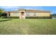 Front exterior of a one-story home featuring stucco, tile roof, and a well-manicured lawn at 4760 Wheel House Dr, New Port Richey, FL 34652