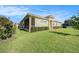 Well-maintained exterior with green lawn and manicured hedge of a one-story stucco home at 4760 Wheel House Dr, New Port Richey, FL 34652