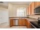 Spacious kitchen featuring granite counters, stainless steel appliances, and wood cabinets for storage at 4760 Wheel House Dr, New Port Richey, FL 34652