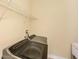 Laundry room showcasing modern front-loading washer and dryer with wire shelving at 4760 Wheel House Dr, New Port Richey, FL 34652