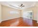 Bright living room features hardwood floors, ceiling fan and bright arched window at 4760 Wheel House Dr, New Port Richey, FL 34652
