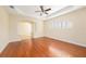 Bright living room features hardwood floors, ceiling fan and classic archway at 4760 Wheel House Dr, New Port Richey, FL 34652