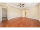 Bright living room features hardwood floors, ceiling fan and classic archway at 4760 Wheel House Dr, New Port Richey, FL 34652