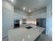 Bright kitchen with stainless steel appliances, quartz countertops, and a spacious center island at 4947 Ribbon Rock Cv, Lakewood Ranch, FL 34211