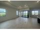 Bright, airy living room featuring large windows, recessed lighting, and sliding glass doors at 4947 Ribbon Rock Cv, Lakewood Ranch, FL 34211
