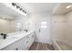 Bright bathroom features dual sinks, a large mirror, a bathtub and modern finishes at 513 Sportsman Park Dr, Seffner, FL 33584