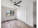 Bright bedroom features luxury floors, a ceiling fan, large window and a closet at 513 Sportsman Park Dr, Seffner, FL 33584