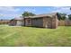 Charming exterior showcasing brickwork and updated siding, set against a lush green lawn at 513 Sportsman Park Dr, Seffner, FL 33584