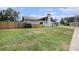 Side yard view features a well maintained lawn, the side of the home and fencing at 513 Sportsman Park Dr, Seffner, FL 33584