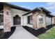 Charming home exterior featuring brick accents, lush landscaping, and walkway leading up to the front door at 513 Sportsman Park Dr, Seffner, FL 33584