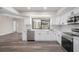 Bright modern kitchen featuring white cabinets, stainless steel appliances, quartz countertops, and garden window at 513 Sportsman Park Dr, Seffner, FL 33584