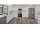 Modern kitchen featuring white cabinets, stainless steel appliances, quartz countertops, and a view of the pool at 513 Sportsman Park Dr, Seffner, FL 33584