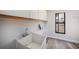 Bright laundry room featuring storage cabinets, modern sink, and window with a view to a room at 513 Sportsman Park Dr, Seffner, FL 33584