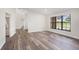 Bright room with a large window offering exterior views and modern flooring throughout at 513 Sportsman Park Dr, Seffner, FL 33584