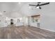 Open-concept living area boasting vaulted ceilings, modern lighting, and sleek wood flooring at 513 Sportsman Park Dr, Seffner, FL 33584