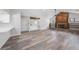 Open living room featuring a brick fireplace, bar area, modern flooring, and abundant natural light at 513 Sportsman Park Dr, Seffner, FL 33584