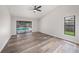 Bright living room features luxury floors, a ceiling fan and views of the pool and backyard at 513 Sportsman Park Dr, Seffner, FL 33584