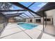 Inviting in-ground pool inside screened lanai for year-round enjoyment and relaxation at 513 Sportsman Park Dr, Seffner, FL 33584