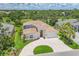 Aerial view of this luxury home showing the tile roof, screened-in lanai and paver driveway at 5217 88Th E St, Bradenton, FL 34211