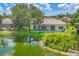 Gorgeous backyard with a screened lanai, lush green lawn and landscaping, and a tranquil pond view at 5217 88Th E St, Bradenton, FL 34211