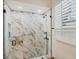 Shower with marble and gold tiles and a mounted shower head, adjacent to a window at 5217 88Th E St, Bradenton, FL 34211