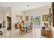 Bright dining room with glass table, stylish light fixture and sliding glass doors to the outdoor area at 5217 88Th E St, Bradenton, FL 34211