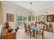 Elegant dining room with a glass table, chandelier, and views of the backyard at 5217 88Th E St, Bradenton, FL 34211