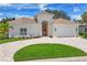 Elegant single-story home with a lush lawn, paver driveway and a charming, arched entry at 5217 88Th E St, Bradenton, FL 34211