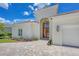 Close up view of this single-story home with a tile roof, lush landscaping and a paver driveway at 5217 88Th E St, Bradenton, FL 34211