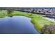 Panoramic aerial view of a lush golf course with mature trees, sparkling lake, and manicured grounds at 5217 88Th E St, Bradenton, FL 34211