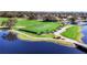Expansive aerial view of the golf course with manicured greens, serene lake, and verdant surroundings at 5217 88Th E St, Bradenton, FL 34211