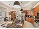 Open concept kitchen with large island, stainless steel appliances and view into the dining area at 5217 88Th E St, Bradenton, FL 34211