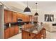 Gourmet kitchen featuring custom cabinetry, granite countertops, black backsplash, and stainless steel appliances at 5217 88Th E St, Bradenton, FL 34211