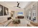 Modern living room with ceiling fan, glass table, tv, neutral colors, and doors to the outdoor space at 5217 88Th E St, Bradenton, FL 34211