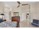 Spacious bedroom with vaulted ceilings, neutral walls, ceiling fan, dresser, and view into other areas of the home at 5217 88Th E St, Bradenton, FL 34211