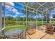 Covered patio with a grill, table and chairs, and views of the lake at 5217 88Th E St, Bradenton, FL 34211