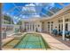 A private pool area features a sparkling pool, spa, and lounge chairs under a screened enclosure at 5217 88Th E St, Bradenton, FL 34211