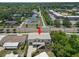Aerial view of elevated home featuring a white exterior, with mature trees and landscaping at 6924 Americana Ne Dr # 167, St Petersburg, FL 33702