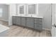 Bathroom featuring modern vanity with dual sinks and a soaking tub at 6924 Americana Ne Dr # 167, St Petersburg, FL 33702
