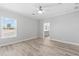 Bedroom featuring wood-look floors and ceiling fan with a bathroom view at 6924 Americana Ne Dr # 167, St Petersburg, FL 33702
