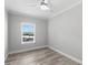 A minimalist bedroom with natural light and wood-look floors at 6924 Americana Ne Dr # 167, St Petersburg, FL 33702