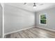 Bright bedroom features wood-look floors and a sunlit window at 6924 Americana Ne Dr # 167, St Petersburg, FL 33702